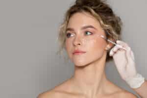 Young woman gazes to the size during her Skinvive treatment for glowing skin