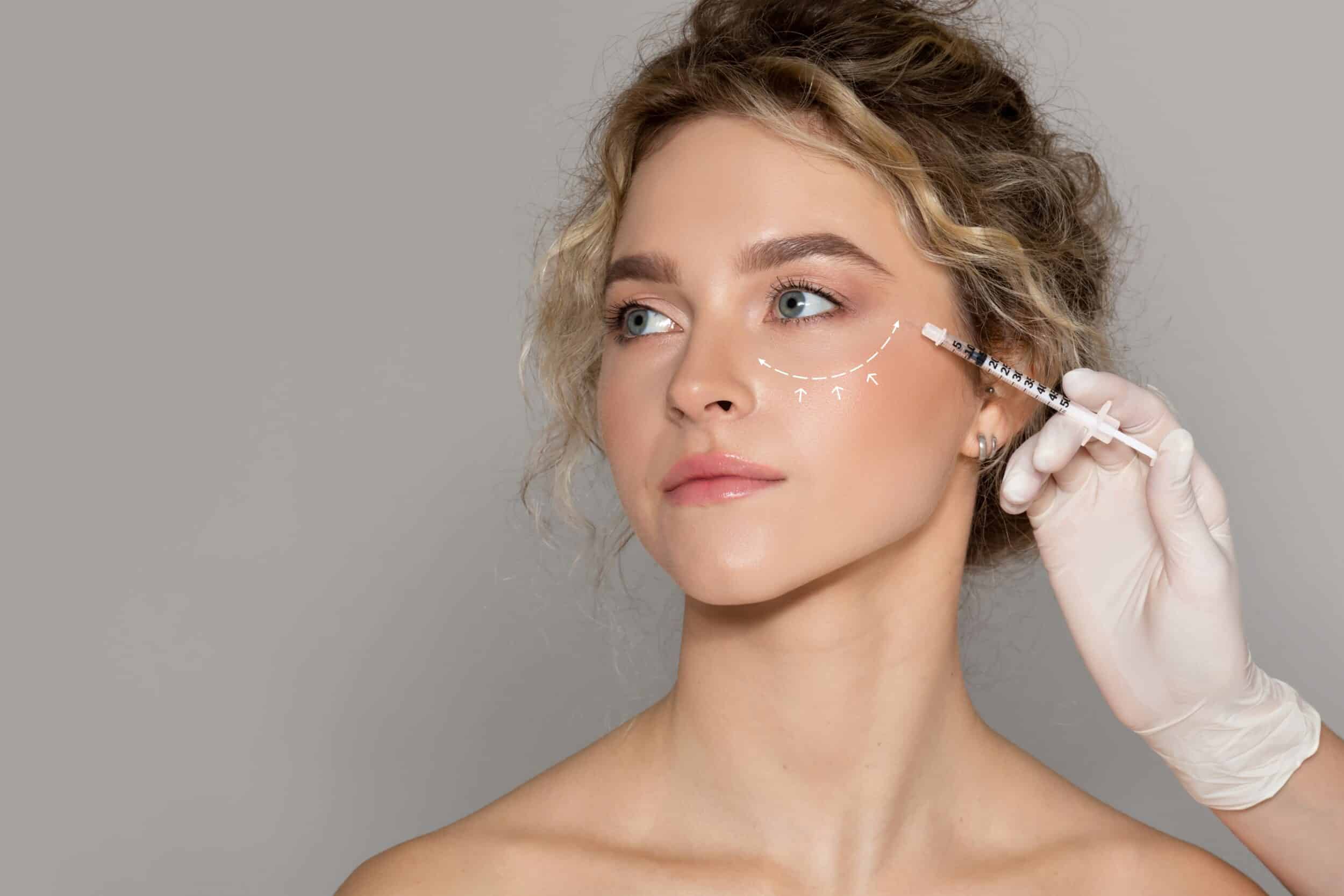 Young woman gazes to the size during her Skinvive treatment for glowing skin