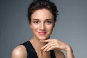 Woman smiles confidently, happy with her beautiful skin after an IPL photofacial